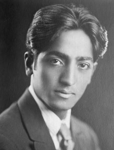 jiddu_krishnamurti J. Krishnamurti is one of the most influential speakers and spiritual teachers of the 20th century. Although he himself would never call himself a teacher - that would be against his whole teaching. He sounds more like a companion, that helps you to grow your own understanding in a friendly and respectful way. The very core of his teaching is the ultimate respect for one’s individuality and freedom, so he is not giving you fixed ideas, but rather invites you to look at the subject, to see and understand for yourself. And the very understanding will bring the change. J. Krishnamurti was born in an orthodox brahmin family, his father was also a member of the Theosofical Society, an esoteric organization that was popular at the time in the western society. When he was 13, one of the leaders of the Society recognized him as a future World Teacher. The boy was taken away from his family and passed a complex process of education to prepare for his great future mission. A special Order is created to support the coming World Teacher, and Krishnamurti becomes its head. Initially the young man was convinced in his mission, however with time he started doubting the teachings of the Theosofical Society and rebelling against his strict mentors. In 1922 J. Krishnamurti moved to a cottage in California, which became his official residence for the rest of his life. Soon after arriving to California Krishnamurti went through a series of “life-changing” spiritual experiences, which initiated “a process”, that continued on and off throughout his whole life. This experience Krishnamurti described as “sacredness”, “benediction”, “immensity” or simply “the other”. After the experience Krishnamurti starts growing confidence, in his speeches he goes further ad further away from the teachings of Theosofical Society. In 1929 in front of thousands of members he dissolves the Order he was heading, marking the turning point in his life and teachings. He breaks up completely with the Theosophical Society and announces the new direction of his work. “I maintain that truth is a pathless land, and you cannot approach it by any path whatsoever, by any religion, by any sect… Truth cannot be organized, nor should any organization be formed to lead people along a particular path... I do not want followers, and I mean this. The moment you follow someone you cease to follow Truth… I am concerning myself with only one essential thing: to set man free. I desire to free him from all cages, from all fears, and not to found religions, new sects, nor to establish new theories and new philosophies.” In the following years Krishnamurti continues speaking all over the world, a new publishing house is established to publish his works. He meets a number of scientists and religious leaders to discuss different fields of religion, education, psychology and physics. J. Krishnamurti lived a long life of 90 years and for 70 years he was speaking. According to his teaching he never formed any movement and never had followers, he denied the very concept of guru and disciple. The key concepts of his teaching are freedom and de-conditioning, breaking up with the past experience. All men’s actions are rooted in the mind, and the mind is just an accumulation of thoughts, which are coming from the past experience, education and society. The ego, personality is just a series of memories. Every society or religion fills individual with its own fixed ideas, with time he becomes identified with them, and they become more important than the facts of life. Because of these ideas, concepts, philosophies there is so much separation and fight in the society and in the individual himself, since the ideas always contradict each other and have no connection to reality. Thus the real changes in society can only come from the transformation of the individual. One has to look deeply into the process of the mind, see and understand how it functions. The result is “choice-less awareness” - the silent and choiceness observation of what is. When this awareness is deep, the mind becomes silent, there is no unconscious or conscious movement of thoughts. The is real freedom - the freedom from the known. “It is the state of a mind which says,